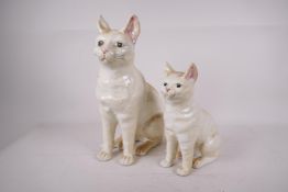 A pair of Portuguese pottery figures of cats, largest 12" high