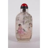 A reverse decorated glass snuff bottle decorated with an erotic scene, character inscription