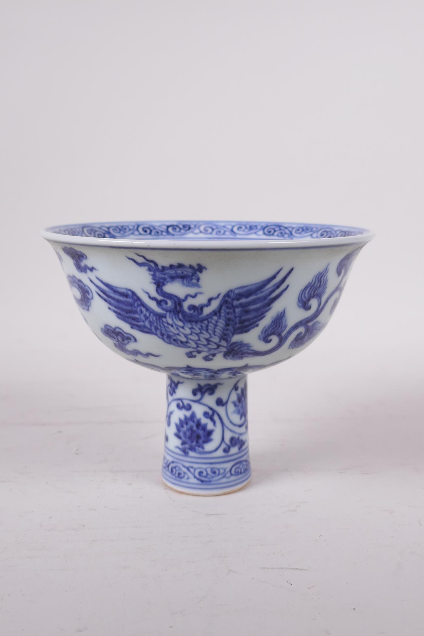 A Ming style blue and white porcelain stem bowl with phoenix decoration, Chinese, 4" high x 5"