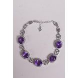 A 925 silver bracelet set with amethysts encircled by cubic zirconia, 7" long