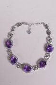 A 925 silver bracelet set with amethysts encircled by cubic zirconia, 7" long