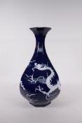 A Chinese blue glazed porcelain pear shaped vase with incised dragon decoration, 13" high