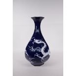 A Chinese blue glazed porcelain pear shaped vase with incised dragon decoration, 13" high