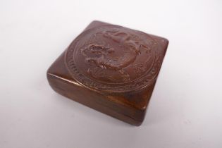 A bronzed copper ink box with repousse dragon decoration to the cover, impressed mark to base,