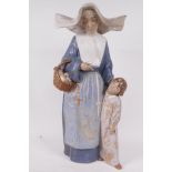 A 1970s Lladro porcelain figure of a nun with a small child, 'Charity', No L212, 16" high