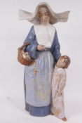 A 1970s Lladro porcelain figure of a nun with a small child, 'Charity', No L212, 16" high