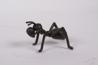 A Japanese Jizai style bronze incense stick holder in the form of an ant, 2" long