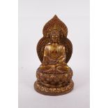 A Chinese filled bronze figure of buddha seated on a lotus throne, impressed four character mark