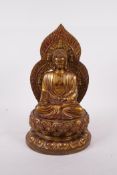 A Chinese filled bronze figure of buddha seated on a lotus throne, impressed four character mark