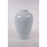 A celadon glazed porcelain jar with raised underglaze lotus flower decoration, incised six character