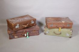 Four vintage suitcases (2 leather and 2 canvas) with original travel labels, largest 29" x 17"