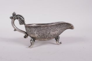 A Chinese white metal libation cup engraved with mythical creature decoration, four character mark