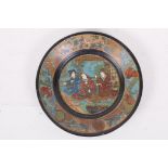 A lacquered papier mache plate, decorated with Japanese figures, 7" diameter