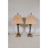 A pair of parcel gilt table lamps made in the form of square section classical columns, 30" high