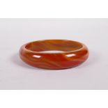 An amber coloured agate bangle, 3" diameter