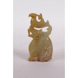 A Chinese carved green hardstone pendant in the form of a dragon and phoenix, 3" high