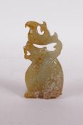 A Chinese carved green hardstone pendant in the form of a dragon and phoenix, 3" high