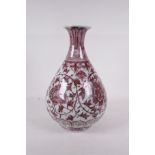 A Chinese red and white porcelain pear shaped vase with scrolling floral decoration, 12" high, A/F