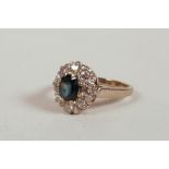 An 18ct white gold dress ring, set with a sapphire and eight diamonds, sapphire approximately 1ct,