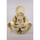 A blanc de chine porcelain figure of Quan Yin seated on a lotus flower, impressed mark verso, 12"
