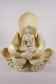 A blanc de chine porcelain figure of Quan Yin seated on a lotus flower, impressed mark verso, 12"