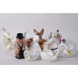 A collection of pottery and porcelain figurines to include an Isle of Man fairing, Poole Pottery