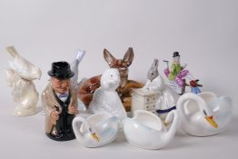 A collection of pottery and porcelain figurines to include an Isle of Man fairing, Poole Pottery