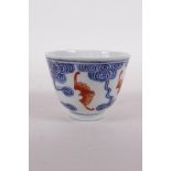 A Chinese blue and white porcelain tea bowl with iron red bat decoration, Quing six character mark