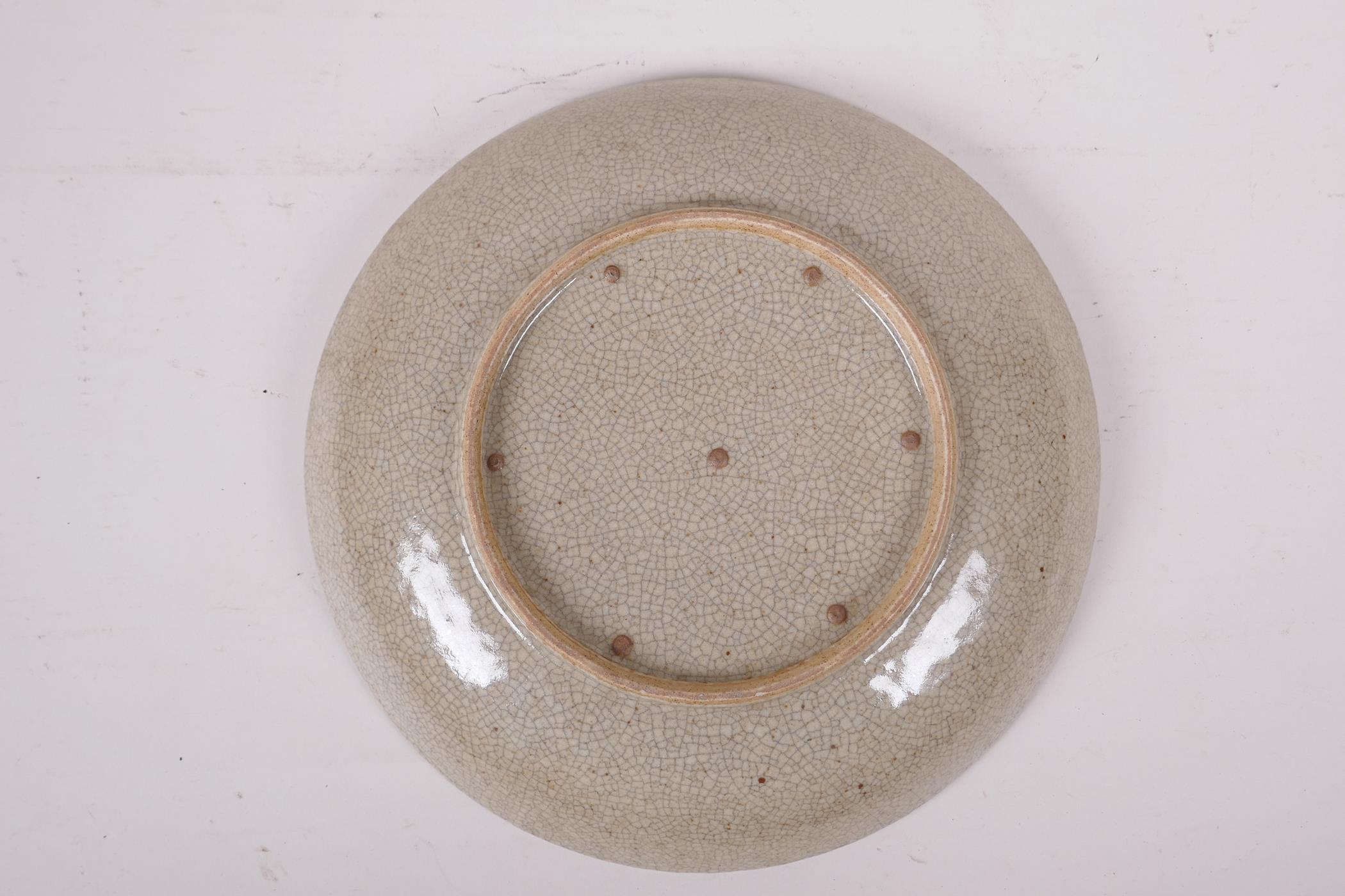 A Chinese crackle ware dish with blue, white and red temple lion decoration, 10" diameter - Image 2 of 2