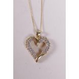A 14ct yellow gold heart shaped pendant necklace, set with diamonds