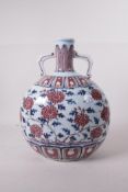 A Chinese blue, white and red porcelain two handled moon flask with floral decoration, 11" high