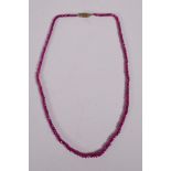 A graduated and faceted spinel bead necklace, 16" long