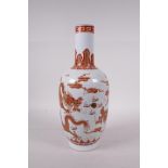 A Chinese red and white porcelain vase decorated with two dragons chasing the flaming pearl, with