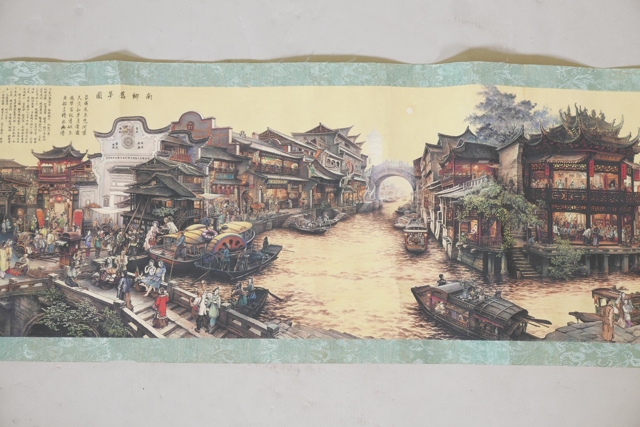 A Chinese printed scroll depicting a town scene, with character inscription panels to either end,
