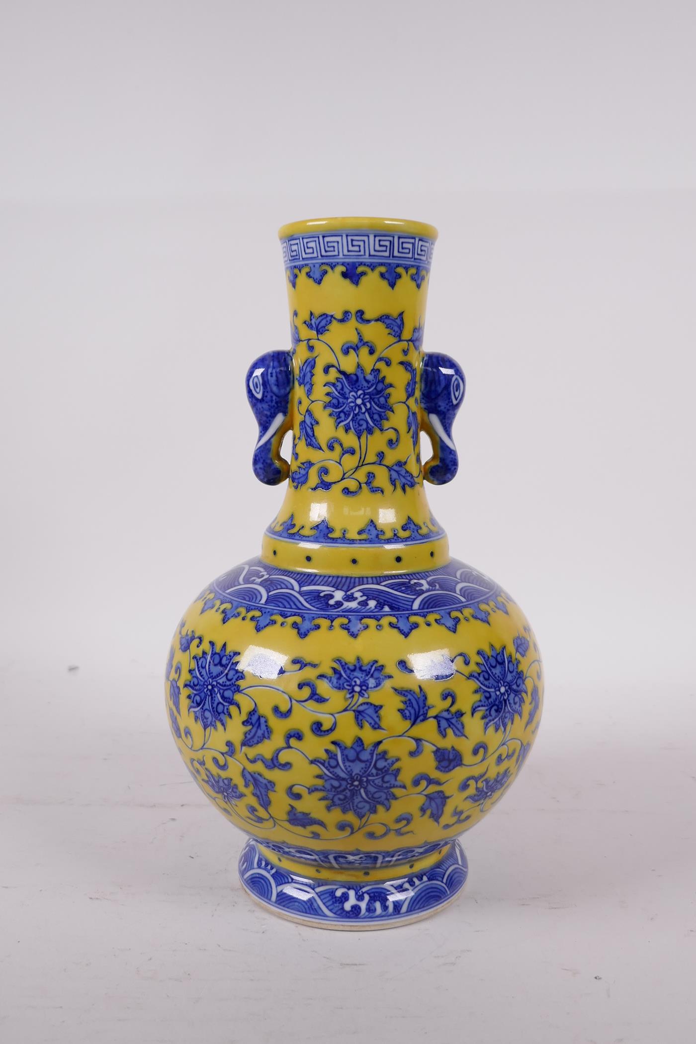 A Ming style yellow ground porcelain vase with two elephant mask handles, with blue and white