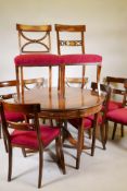 A mahogany drawleaf dining table with dummy drawer frieze, raised on a turned column and splay feet,