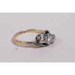 An 18ct yellow gold and platinum ring, set with three diamonds, approx 0.3ct, 3.1g, size J