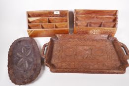 Four Indian carved hardwood items, two stationery racks and two trays, largest 21" x 12"