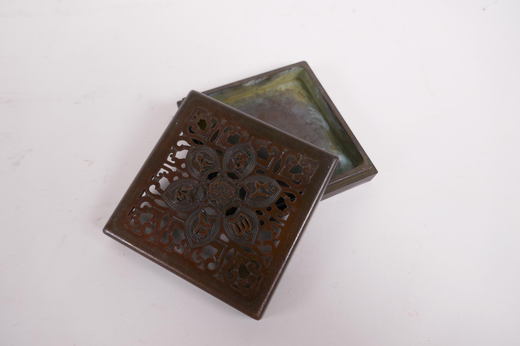 A sino Tibetan bronze incense box and pierced cover, decorated with auspicious symbols, impressed - Image 3 of 4