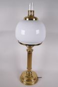 A brass and glass electric table lamp made in the style of an oil lamp, 26" high