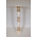 An alabaster pedestal with decorative carved bands, 43" high