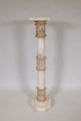 An alabaster pedestal with decorative carved bands, 43" high