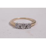 A 9ct gold ring set with three diamonds, 0.7ct, size O