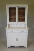 A Continental painted dresser, with glazed upper section on a base of two drawers over two