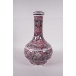 A Chinese red and white bottle vase decorated with mythical creatures, six character mark to base,