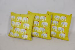 Three yellow Habitat 'Topsy' elephant patterned cushions, 17" x 17"