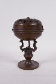 A Chinese bronze ball censer, the cover with pierced dragon decoration, 6" high