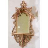 A C19th carved and pierced limewood tabernacle style wall mirror with shelf, 34" long