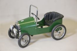 A vintage 'Great Gizmos Ltd' child's classic pedal car in racing green