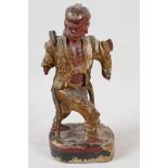 An antique painted Chinese carved wood figure of an angry man, A/F, 9" high